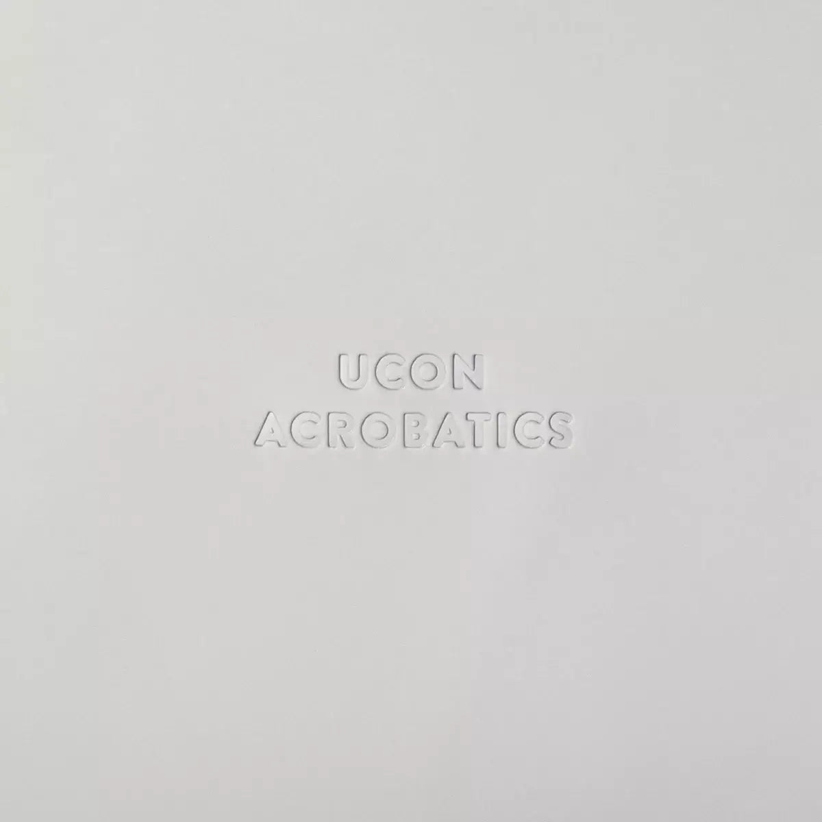 UCON ACROBATICS logo on a white background, showcasing the brand's minimalist design aesthetic.