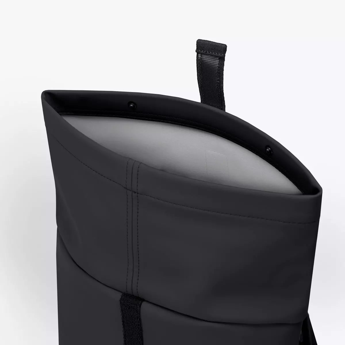 Hajo Mini Lotus Infinity Black Backpack, showing the top opening and interior padding for protection.