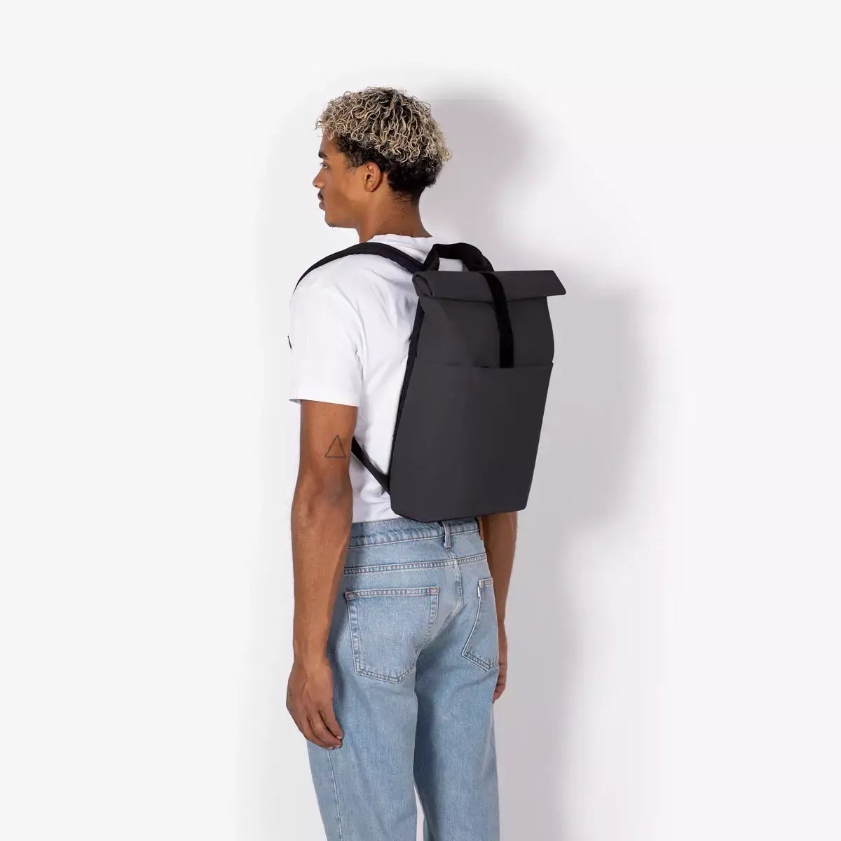 Hajo Mini Lotus Infinity Black Backpack worn by a model, showcasing its sleek design and durable material.