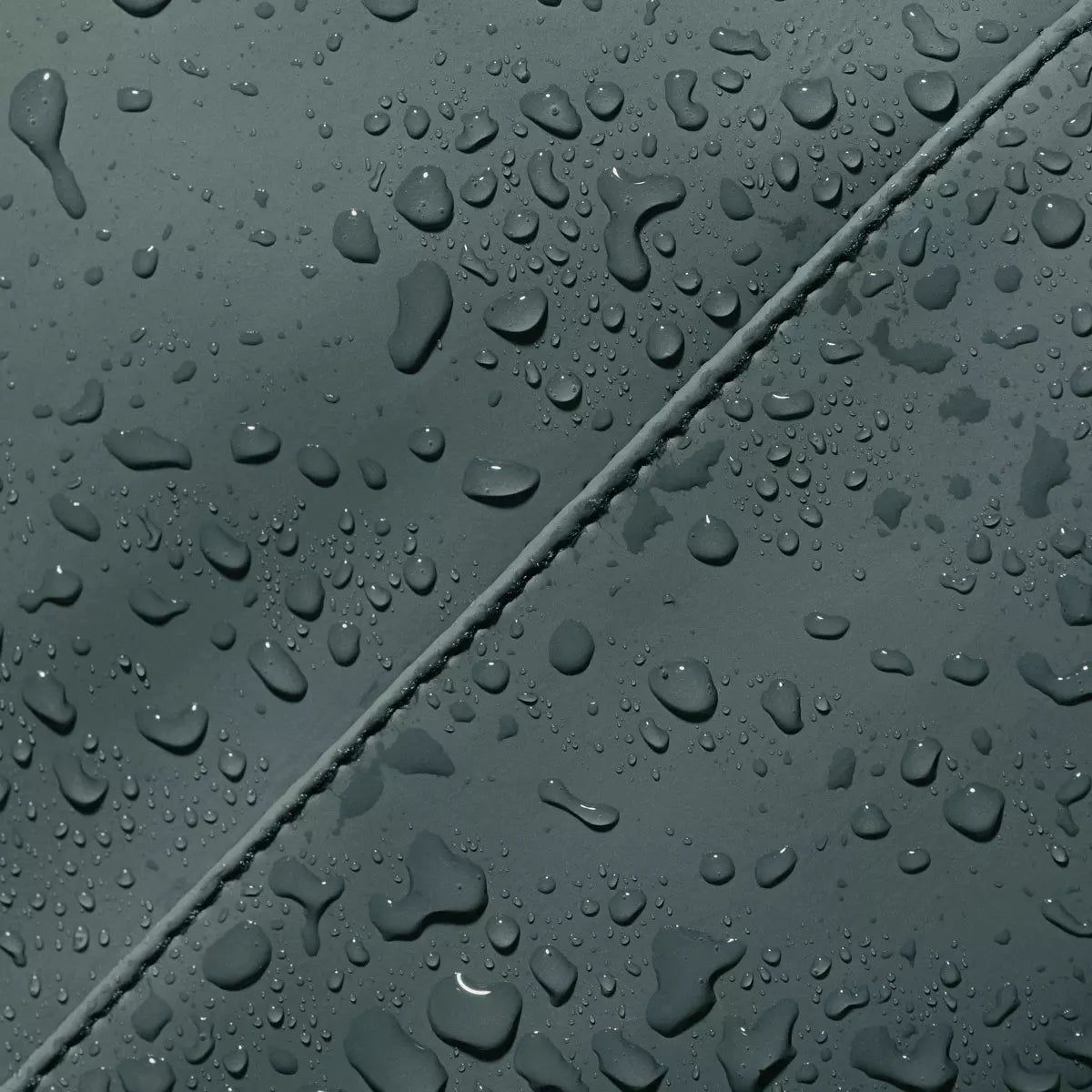 Water droplets on waterproof material of Hajo Mini Lotus Infinity Pine Green Backpack.