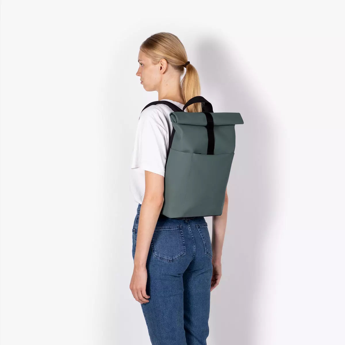 Hajo Mini Lotus Infinity Pine Green Backpack displayed on a model's back, showcasing its stylish and durable design.