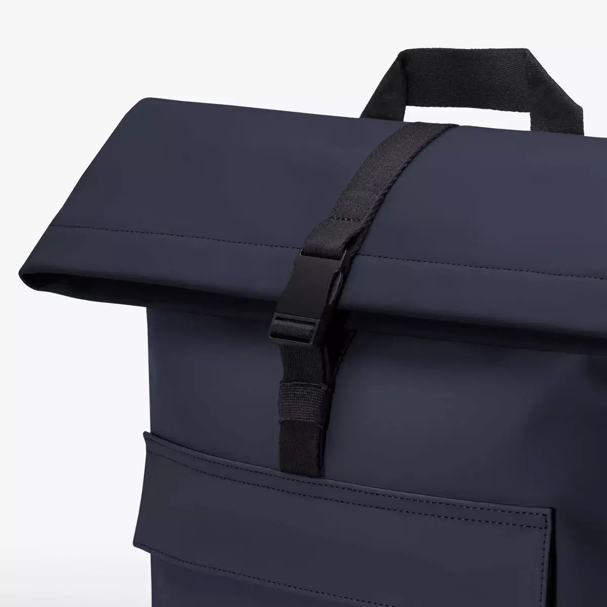 Jannik Medium Lotus Infinity Dark Navy Backpack close-up of waterproof roll-top closure and strap