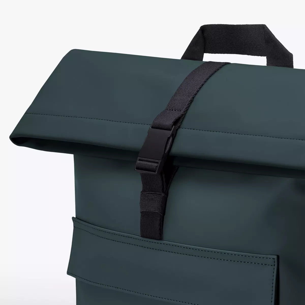 Close-up of the Jannik Medium Lotus Infinity Forest Backpack with roll-top closure and clip.