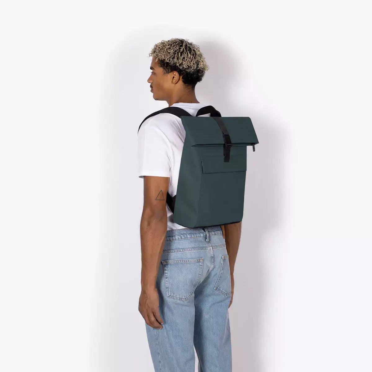 Jannik Mini Lotus Infinity Forest Backpack shown from the back on a model, highlighting its durable design and stylish look.