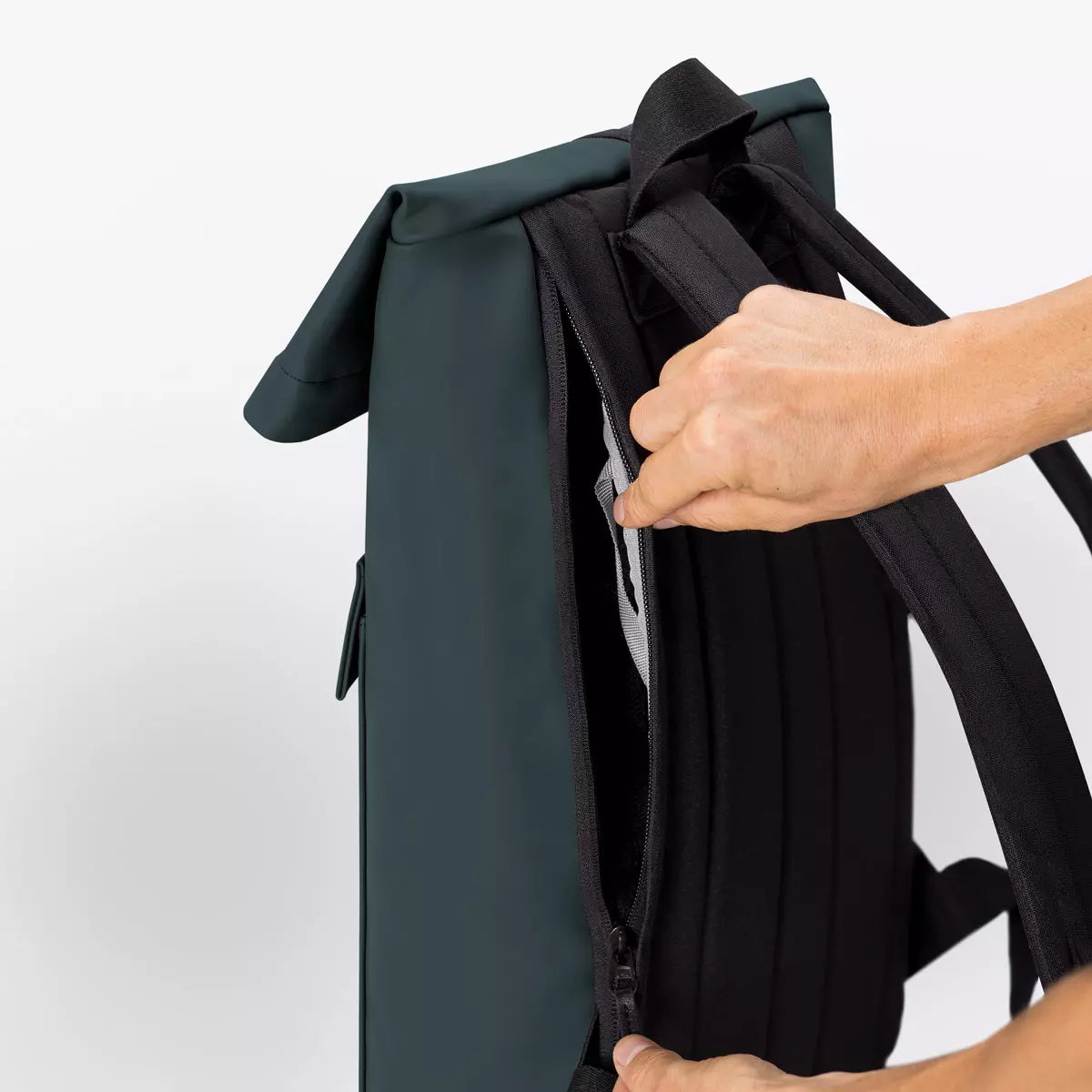 Close-up of the Jannik Mini Lotus Infinity Forest Backpack showcasing the side zipper compartment and roll-top design.