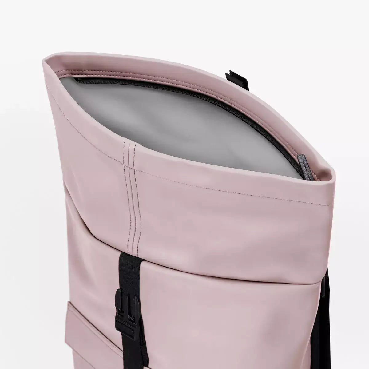 Jannik Mini Lotus Infinity Light Rose Backpack with waterproof roll-top closure and side zipper.