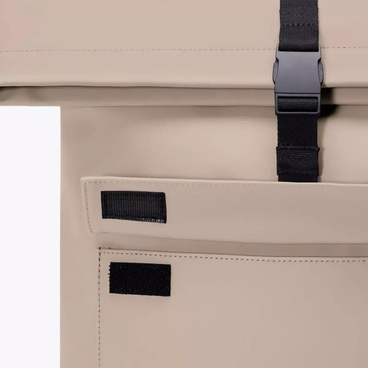 Close-up of the closure and side pocket of the Jannik Mini Lotus Infinity Sand Backpack.