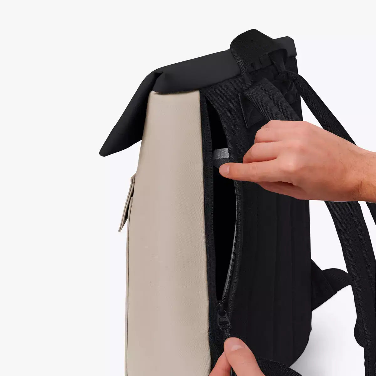 Jasper Aloe Sand Black Backpack showcasing the side zipper and roll-top feature for easy access and convenience.