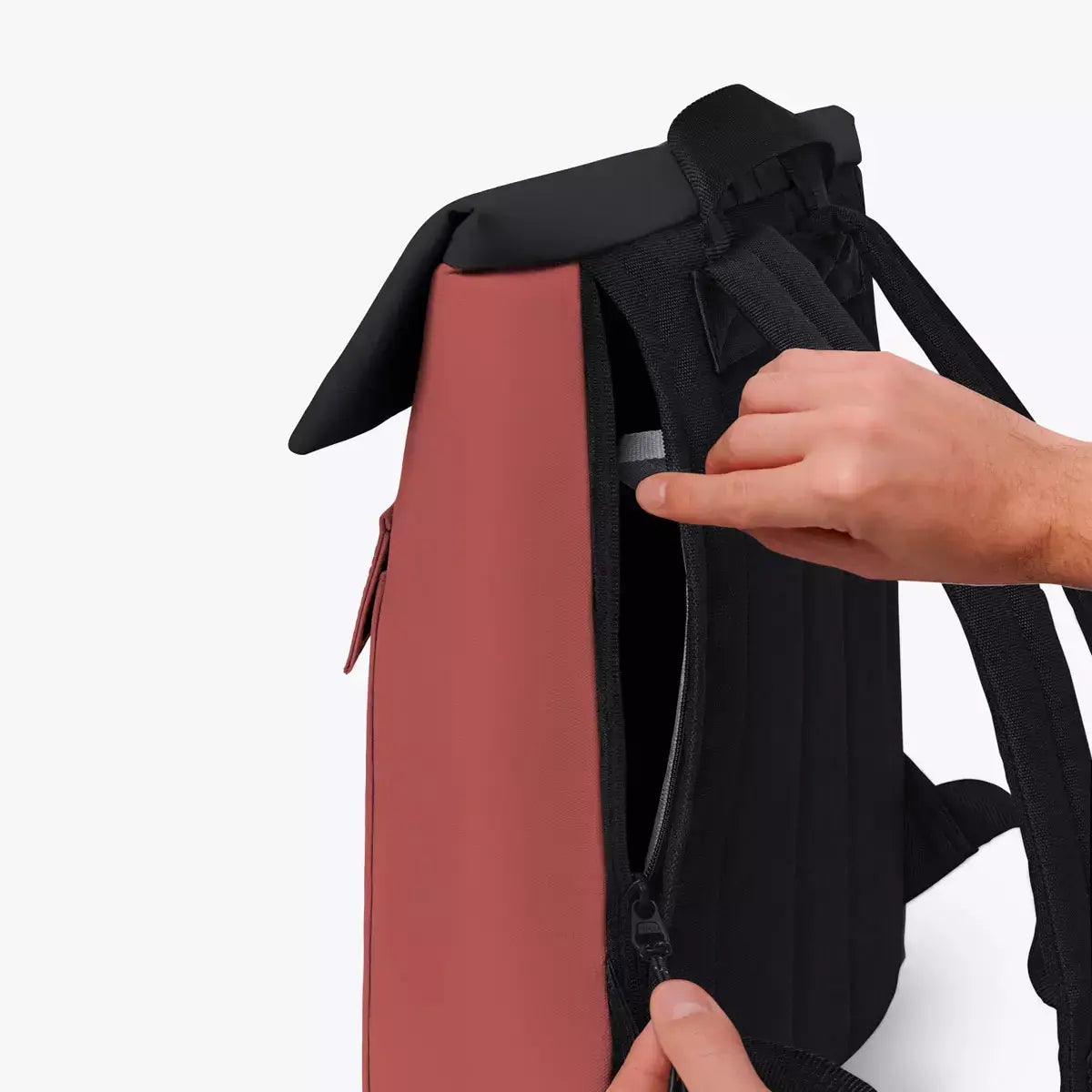 Jasper Mini Aloe Hibiscus Black Backpack showing side zipper and roll-top design for easy access.