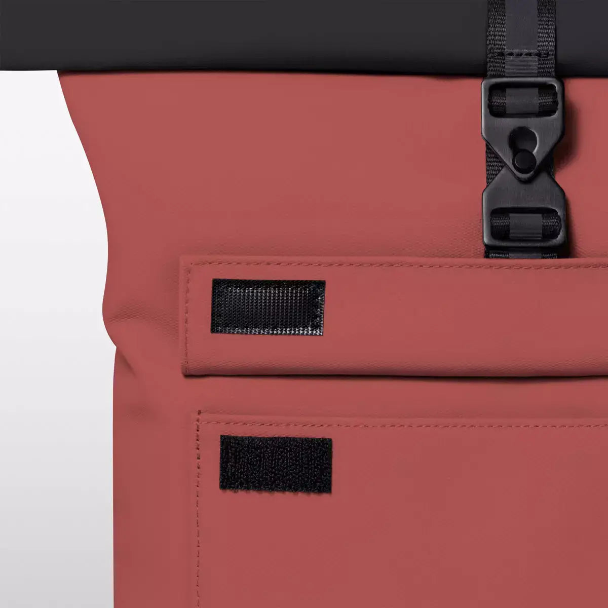 Jasper Mini Aloe Hibiscus Black Backpack waterproof roll-top closure features and metal clip detail.