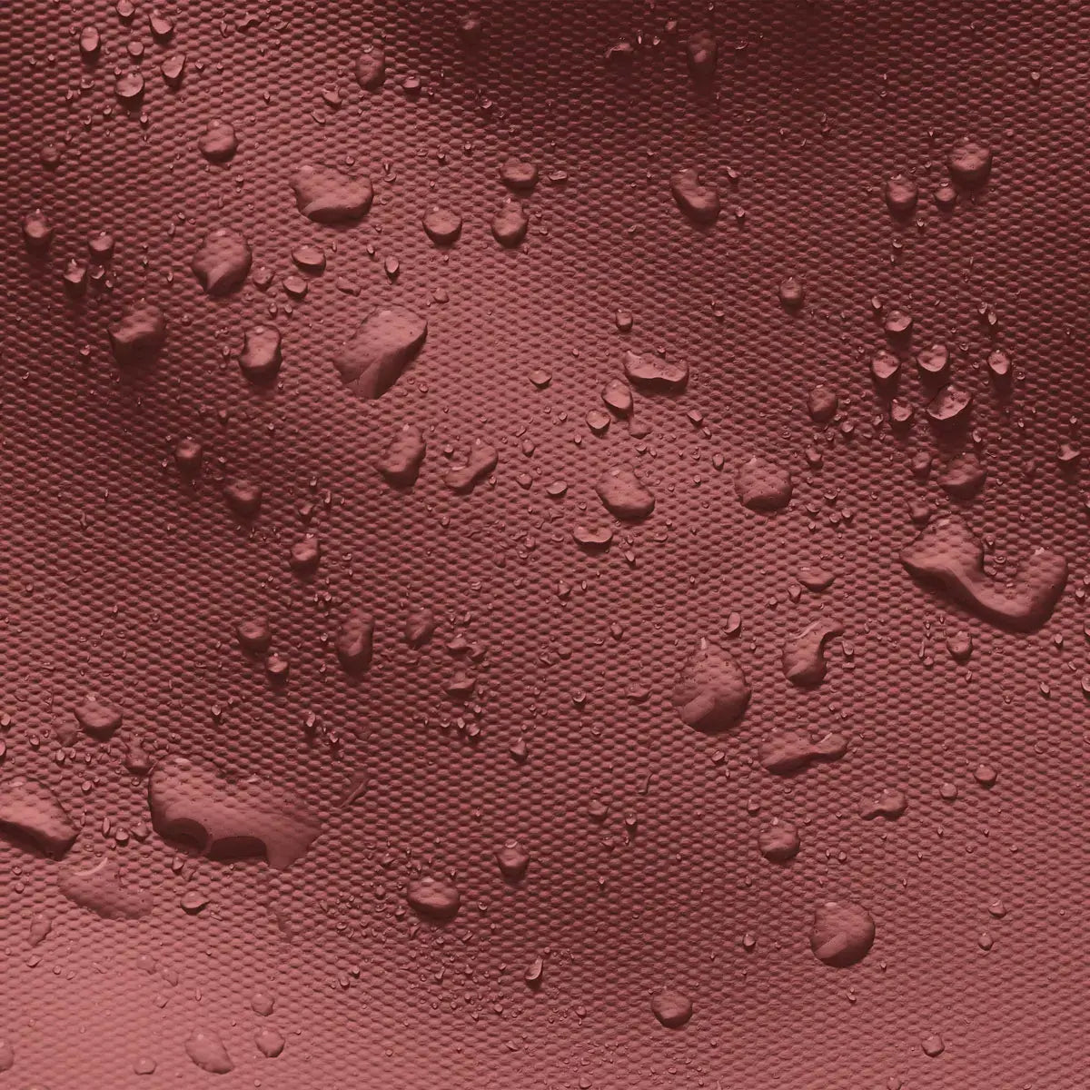 Waterproof fabric texture featuring droplets, ideal for the Jasper Mini Aloe Hibiscus Black Backpack.