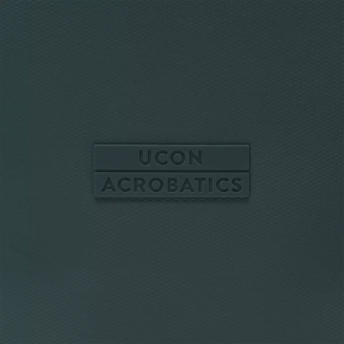 Ucon Acrobatics logo on a textured dark background, showcasing brand identity and design.