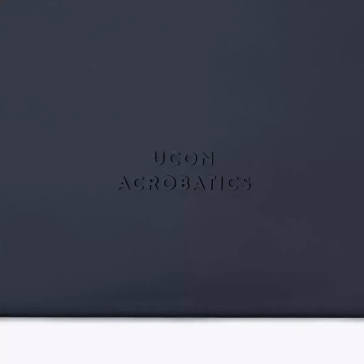 Close-up of Jona Lotus Infinity Dark Navy Bum Bag featuring embossed UCON ACROBATICS logo.