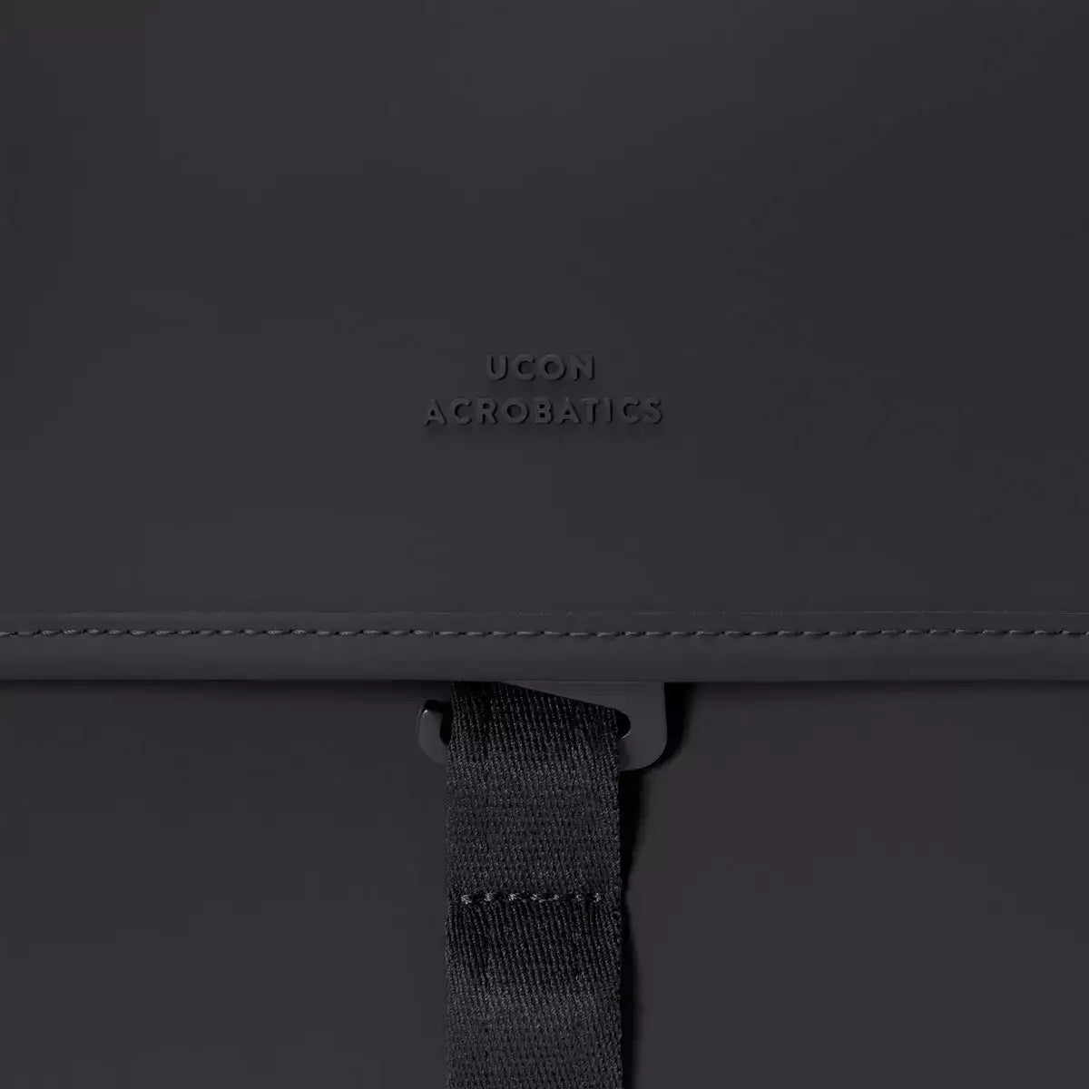 Kumo Medium Lotus Infinity Black Backpack detail showing material and magnetic closure.