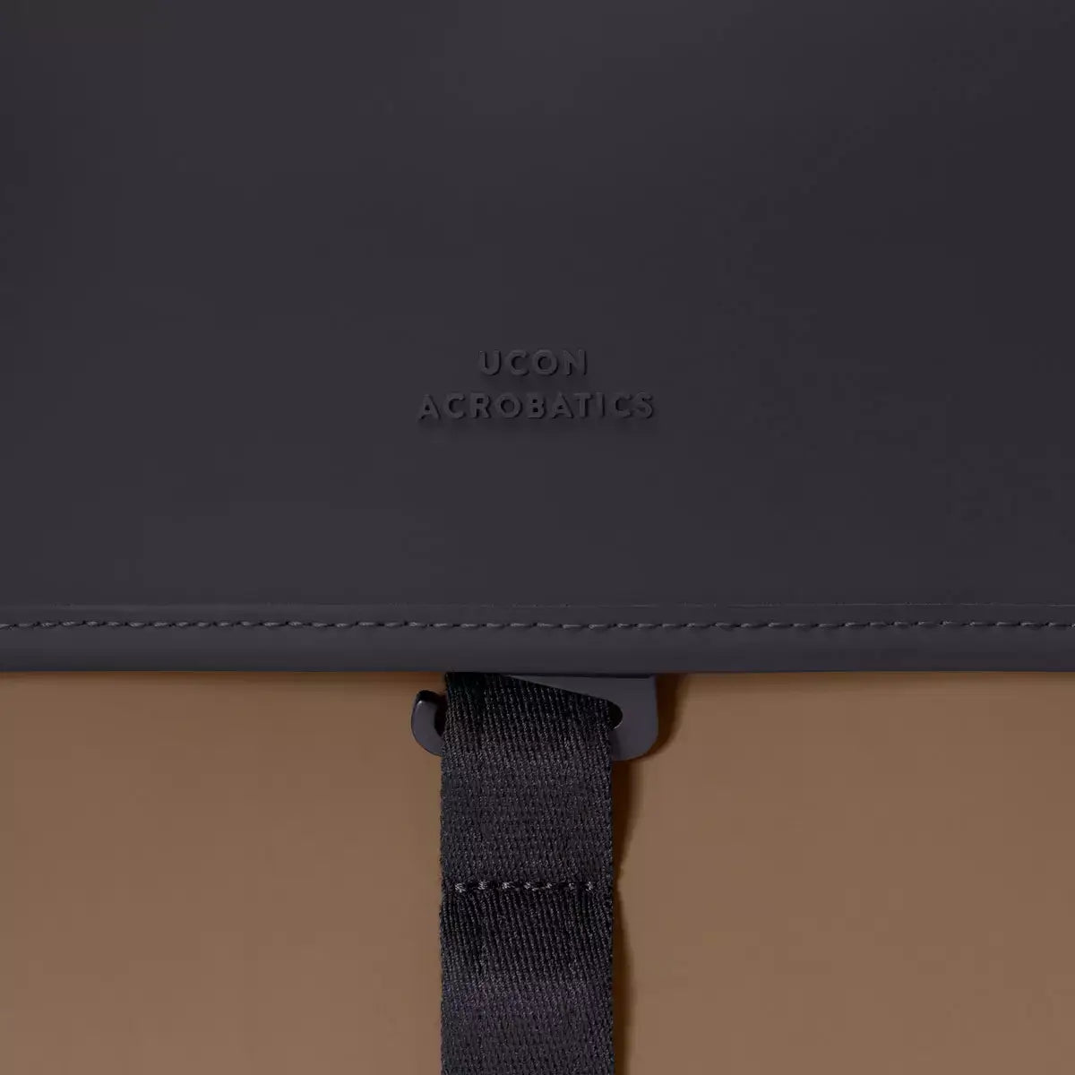 Close-up of UCON Acrobatics logo on a durable backpack strap showcasing sleek design.