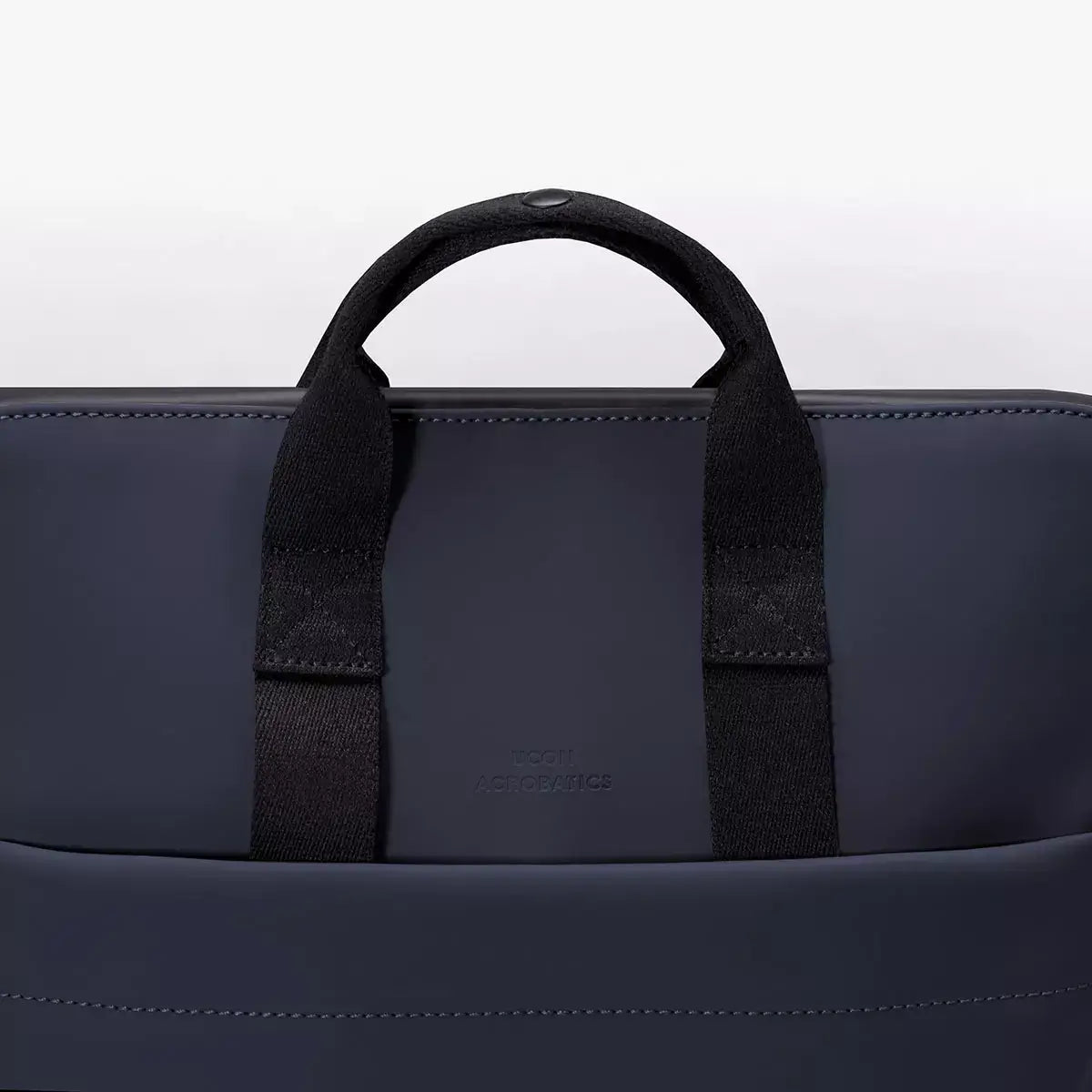 Masao Lotus Dark Navy Backpack close-up of handle detail, showcasing stylish design and functionality.