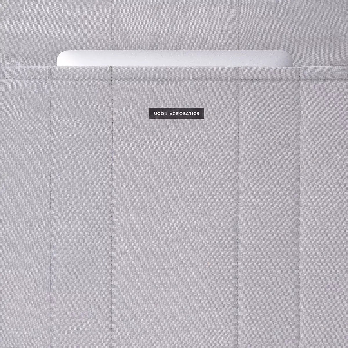 Masao Lotus Dark Navy Backpack featuring a padded compartment for a laptop, showcasing its sleek design and functionality.