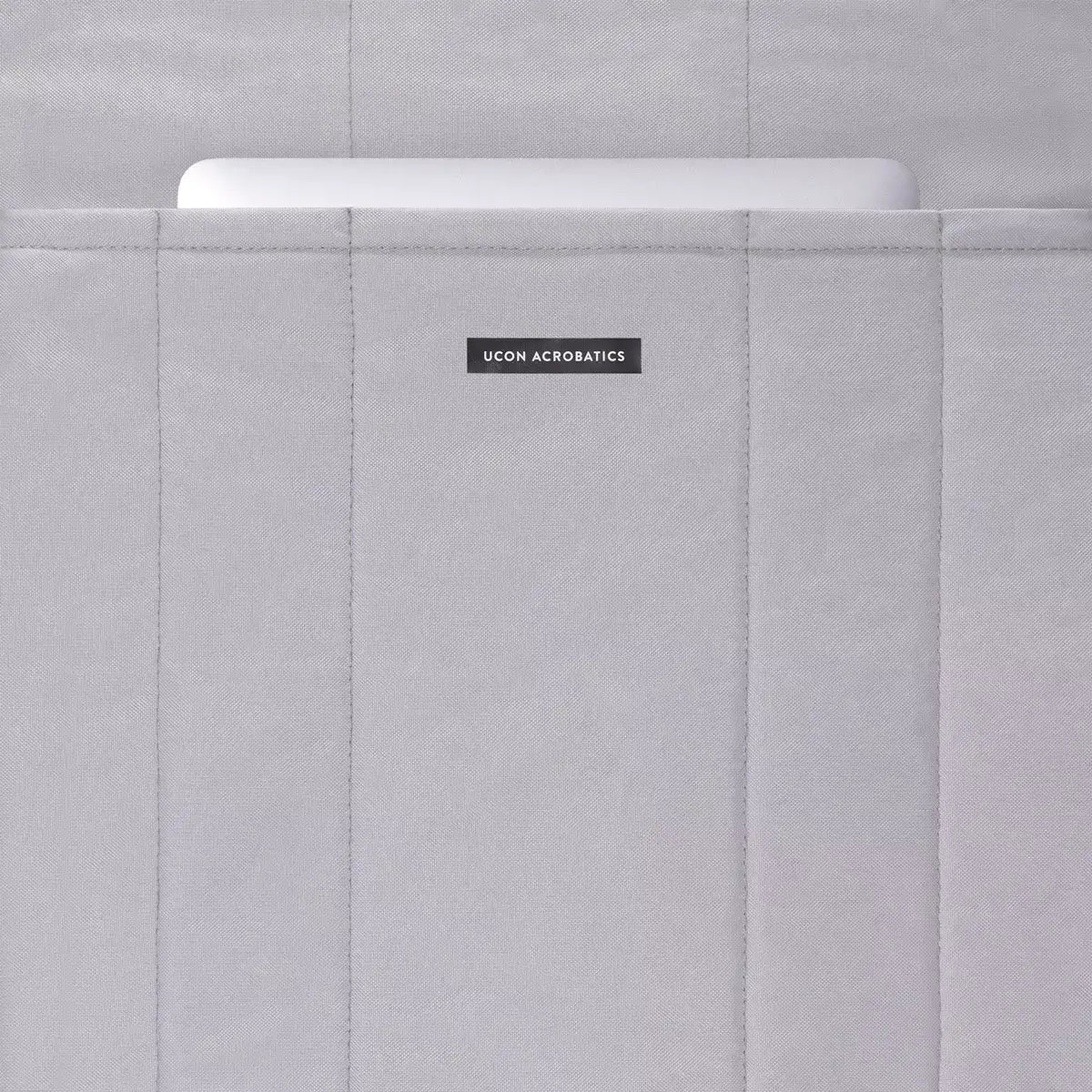 Masao Lotus Light Almond Backpack showing padded laptop compartment with zipper closure.