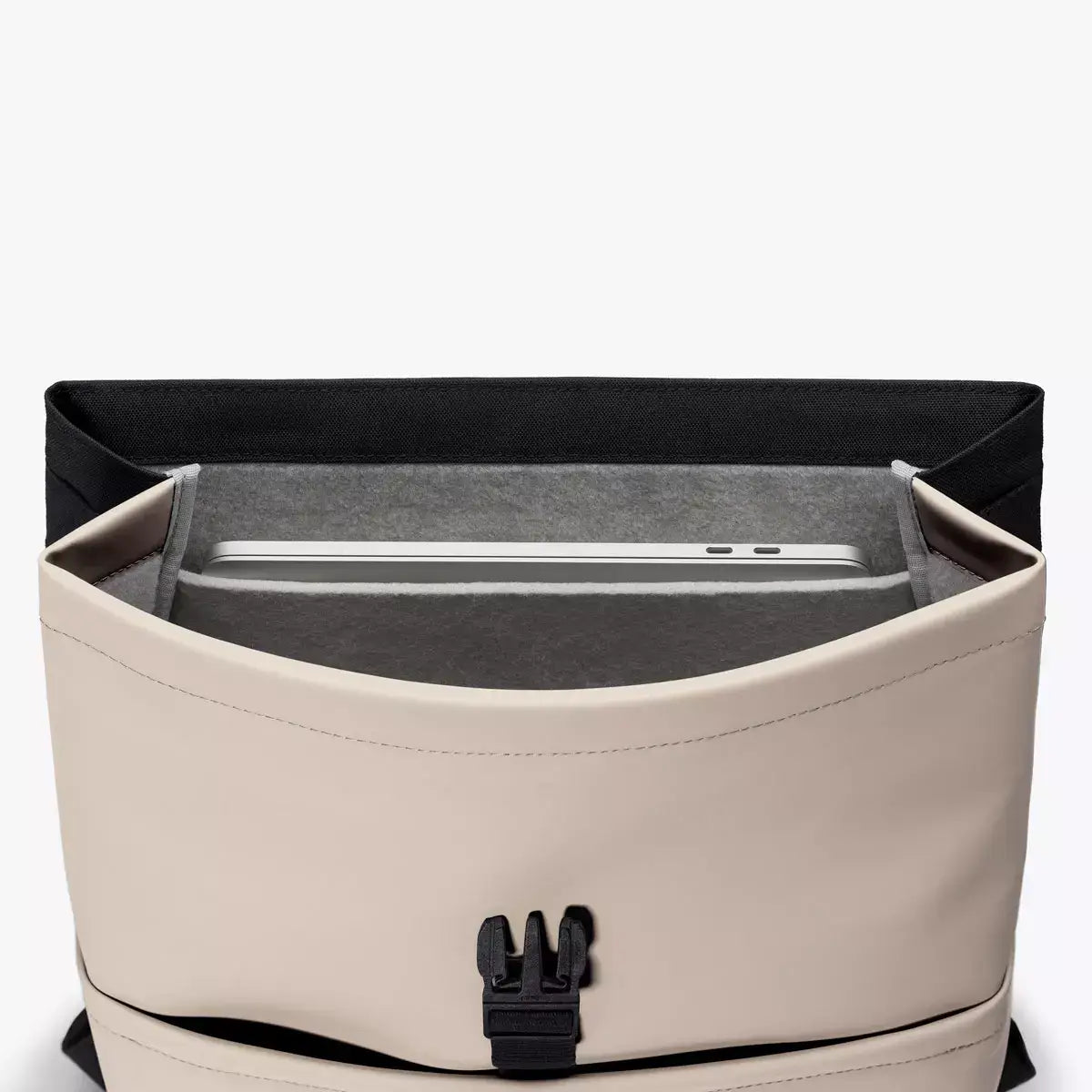 Interior view of Mion Mini Lotus Infinity Light Sand Backpack showing laptop compartment.