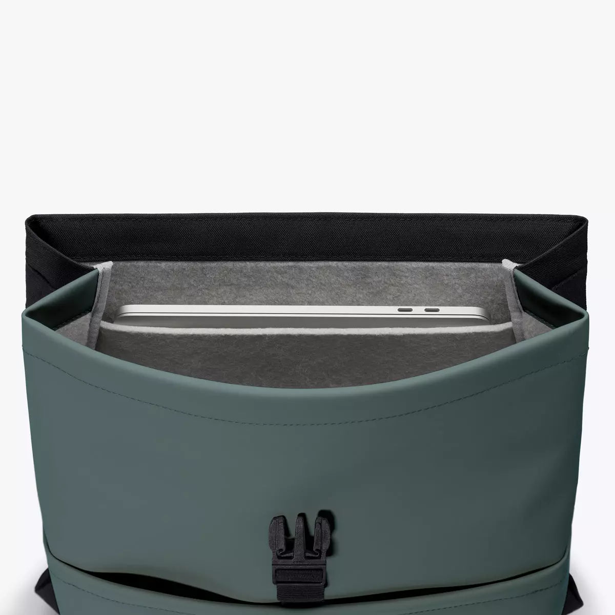 Interior view of the Mion Mini Lotus Infinity Pine Green Backpack showing laptop compartment.