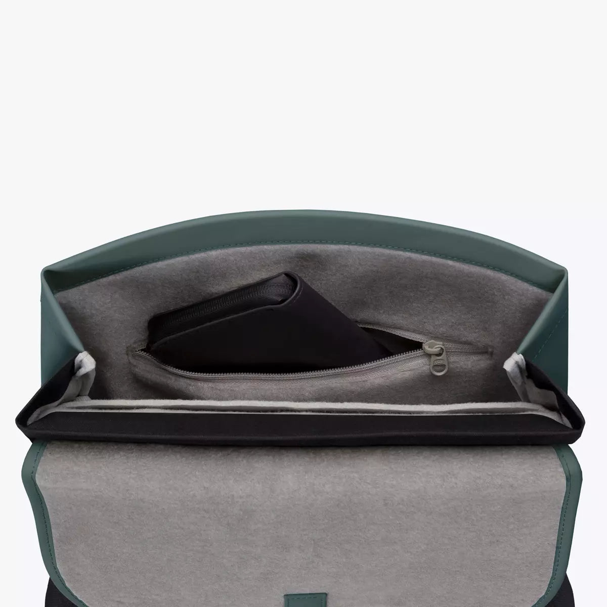 Interior view of the Mion Mini Lotus Infinity Pine Green Backpack showing laptop compartment and zip pocket.