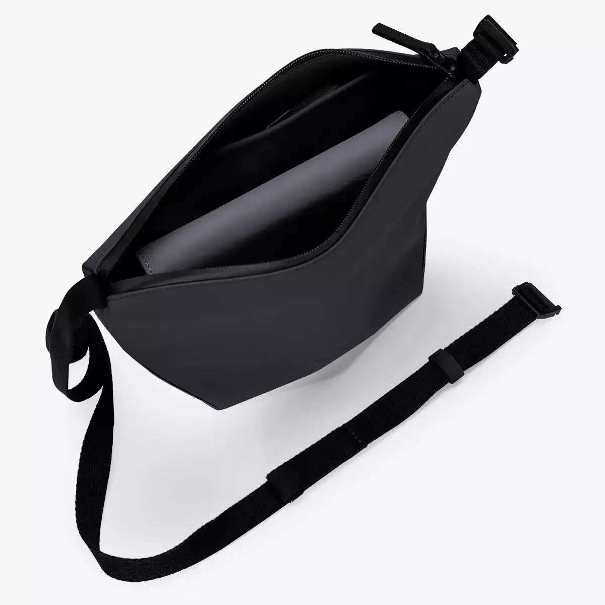 Inside view of the Nola Lotus Black Shoulder Bag showcasing its spacious zipped compartment and adjustable strap.