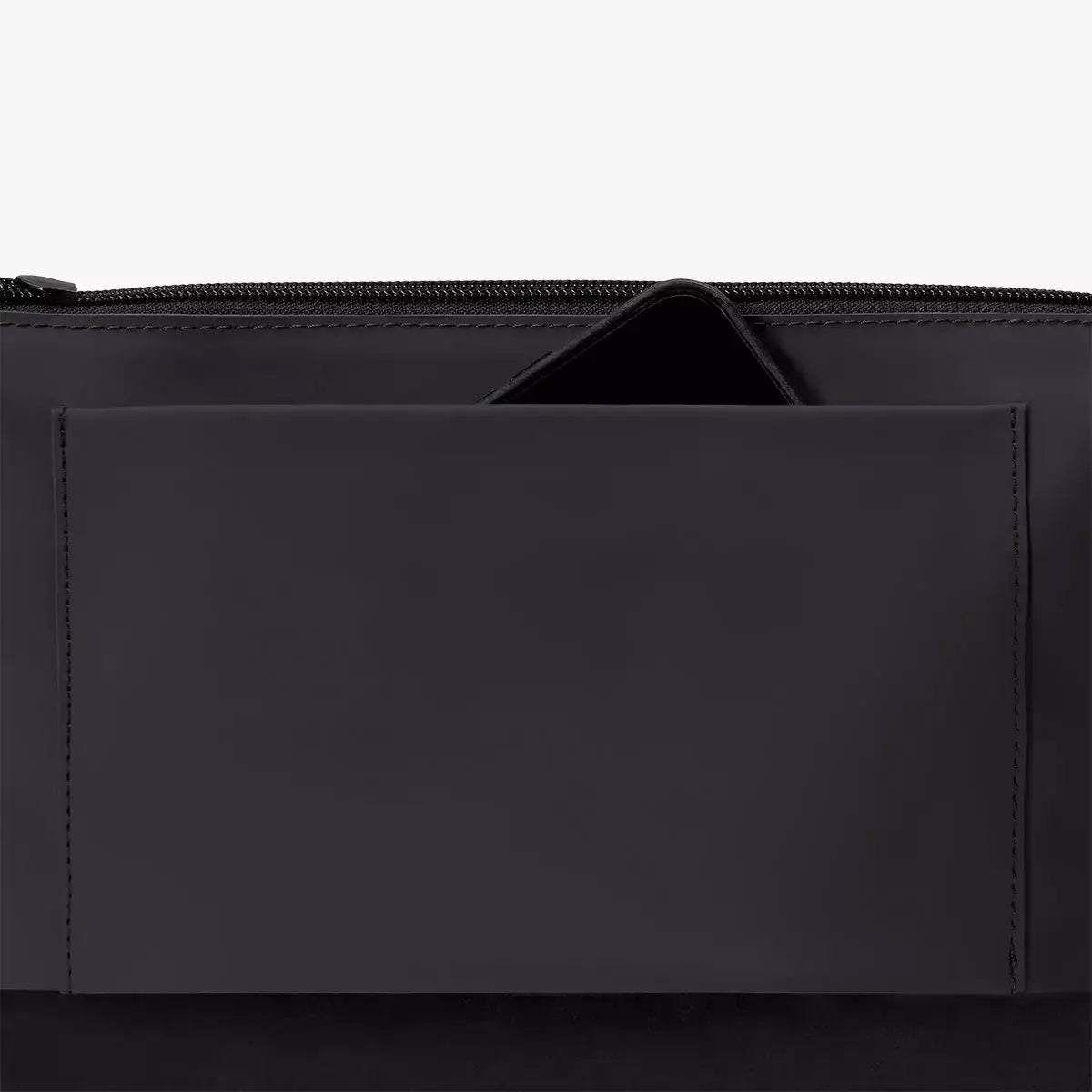 Interior pocket detail of the Nola Lotus Black Shoulder Bag showcasing zipper and sleek design.