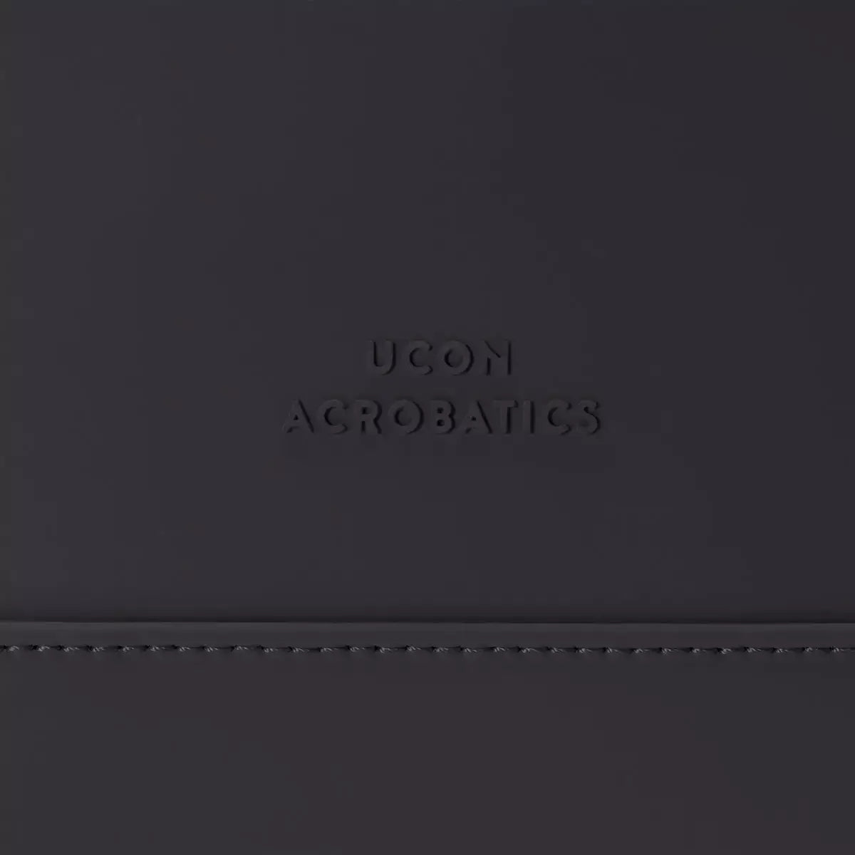 Ucon Acrobatics logo on a sleek black surface, showcasing modern design and branding.