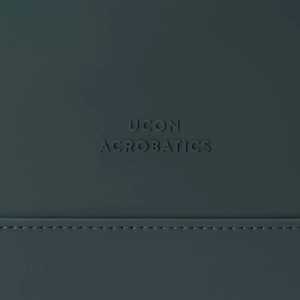 Yuto Medium Lotus Infinity Forest Backpack showcasing UCON Acrobatics embossed logo on a sleek surface.