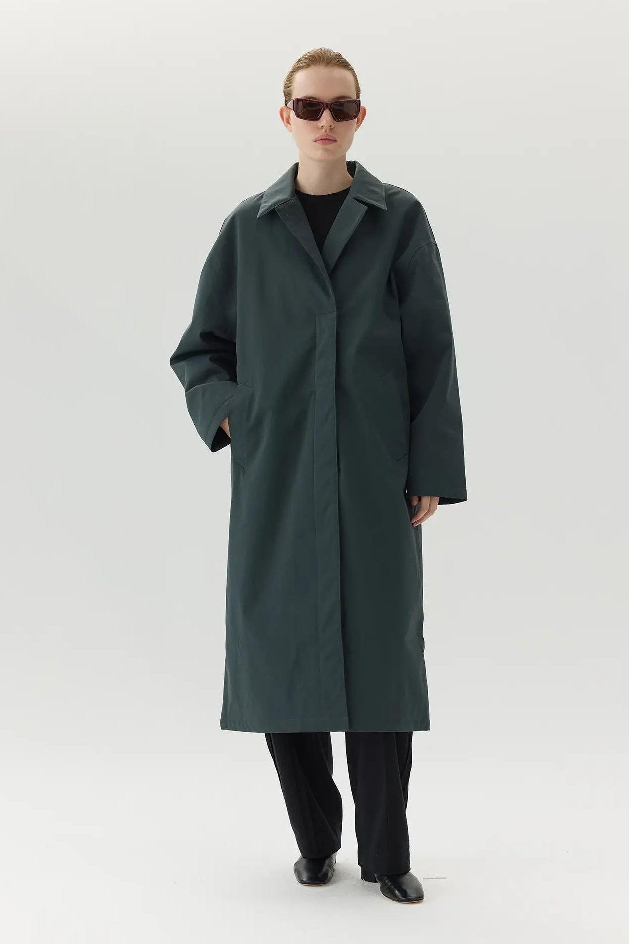 Model wearing the Janice B Ninspin Forest Green Coat, showcasing its casual fit and stylish design.