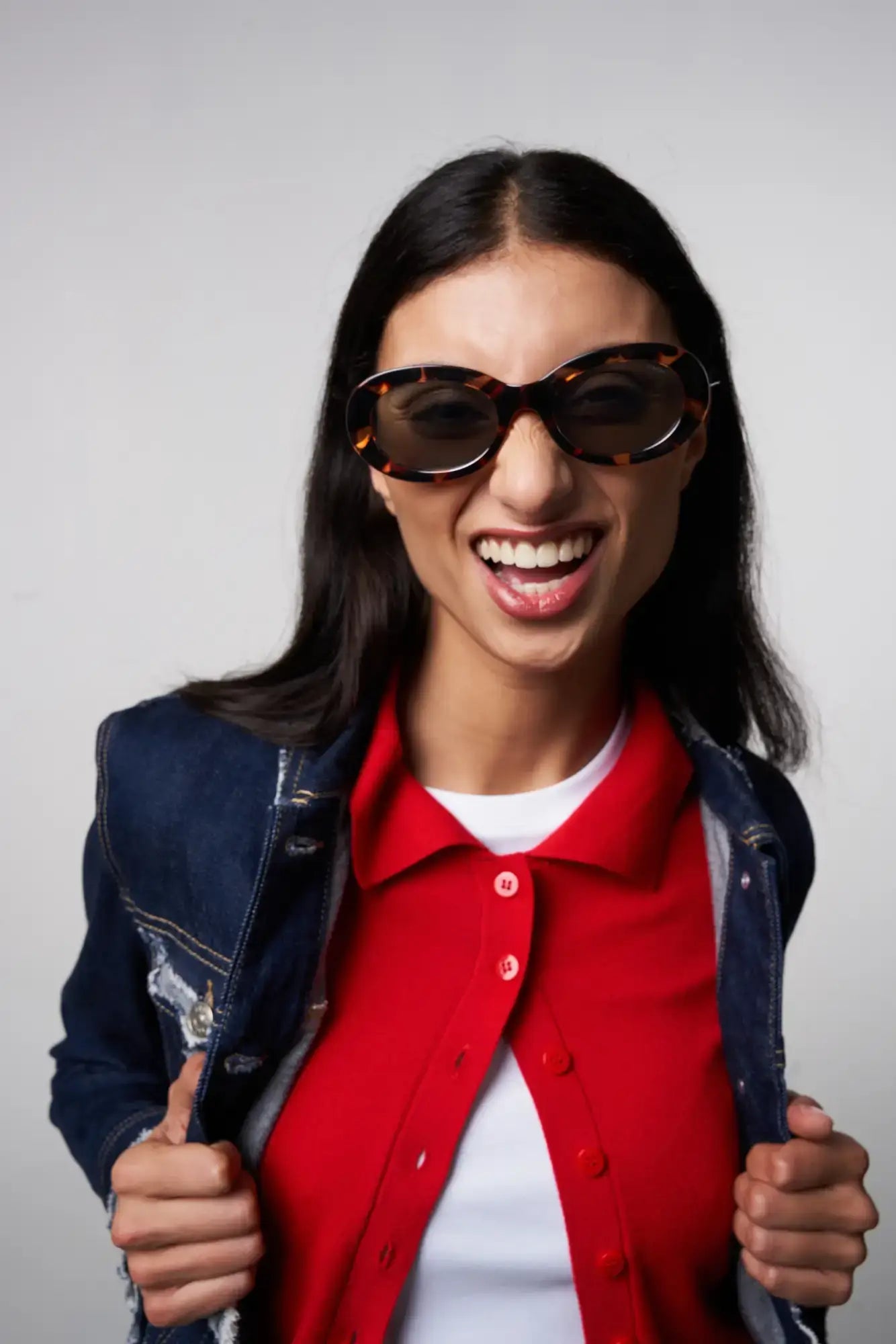 Woman smiling while wearing Luna Havana Sunglasses, featuring a bio nylon frame and polycarbonate lenses.