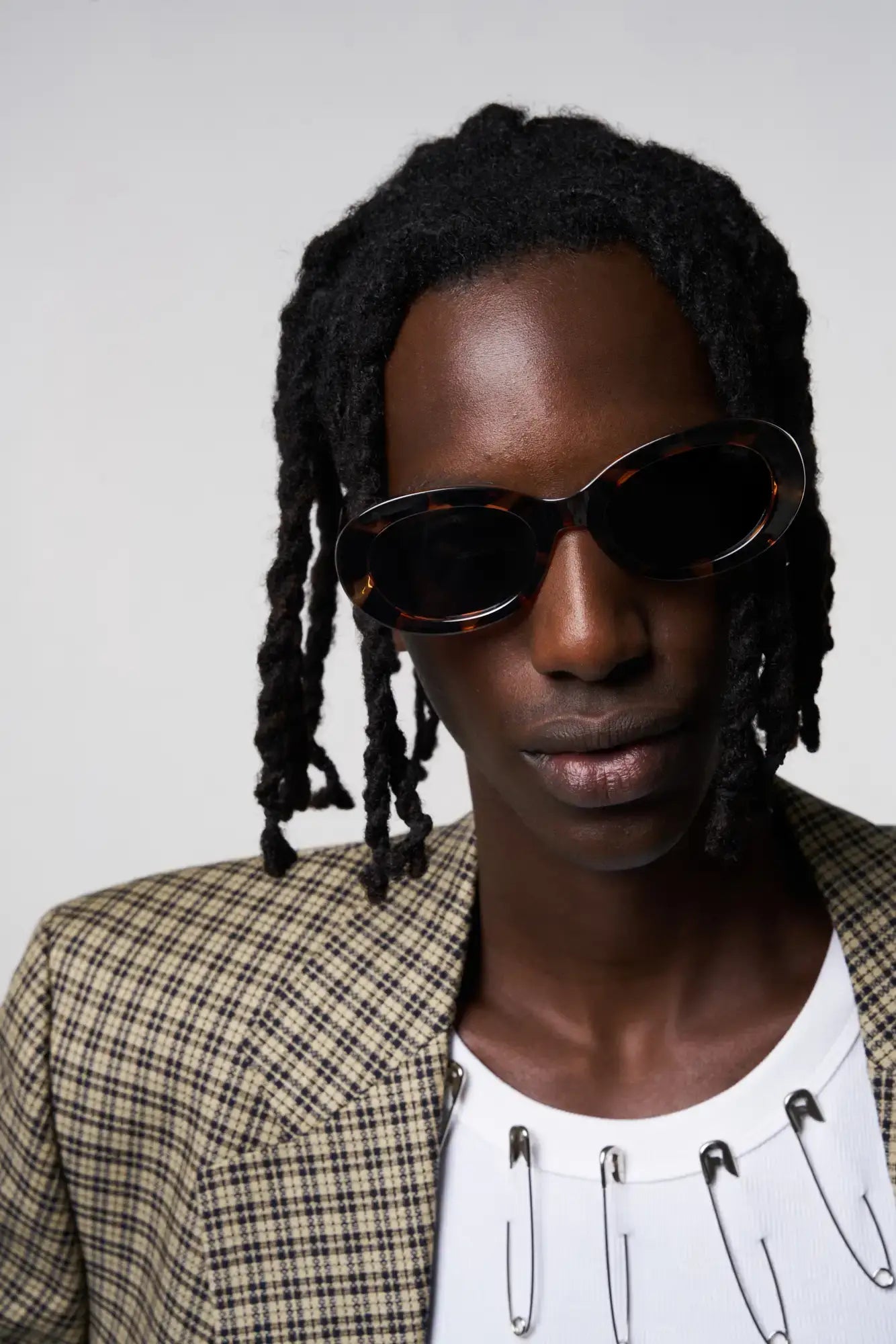 Model wearing Luna Havana Sunglasses with a stylish outfit and expressive look, showcasing modern eyewear fashion.
