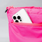 Close-up of a smartphone in a pink bag pocket showcasing functionality and style.