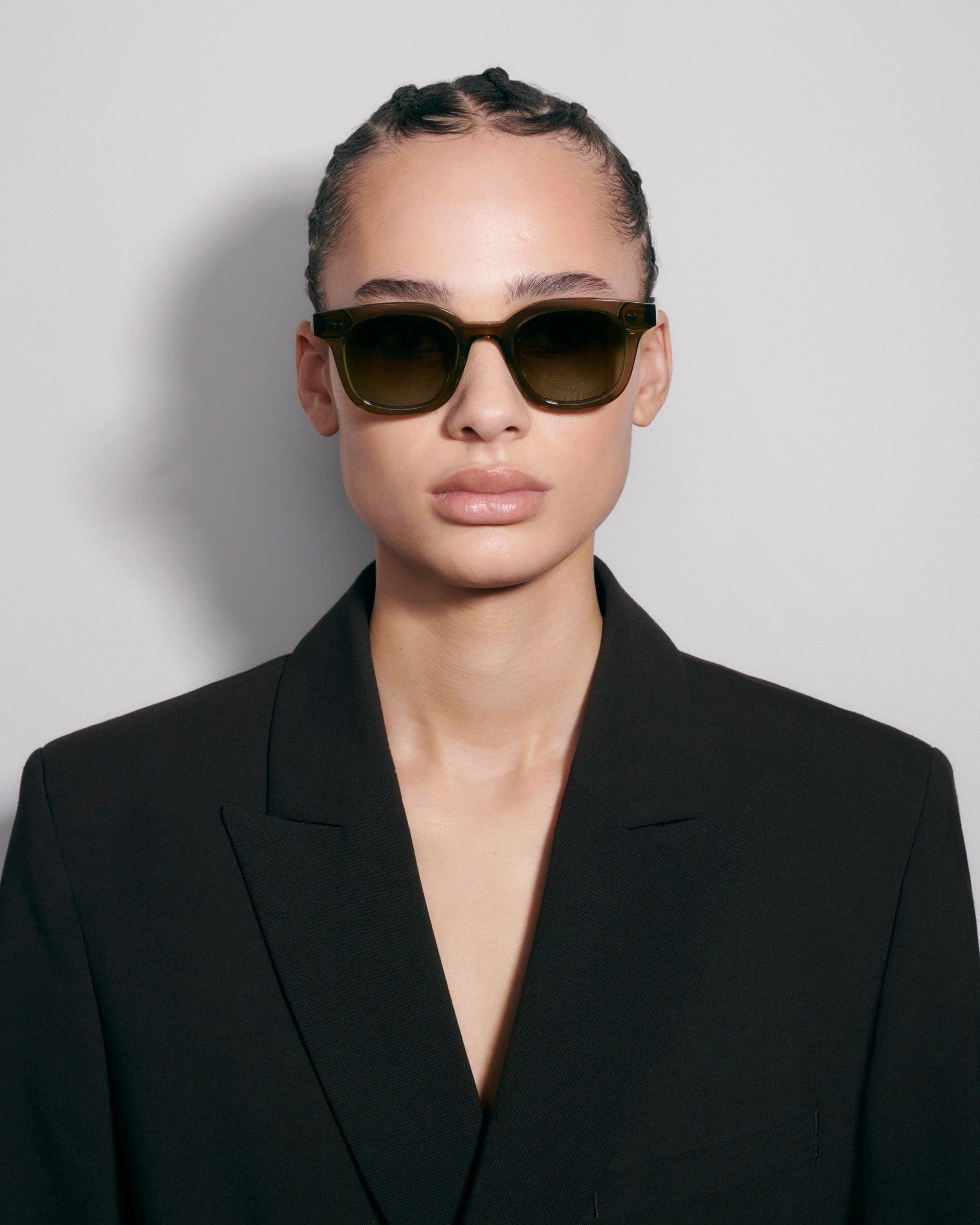 02 Core Green Sunglasses worn by a model, showcasing stylish design and UVA/UVB protection.