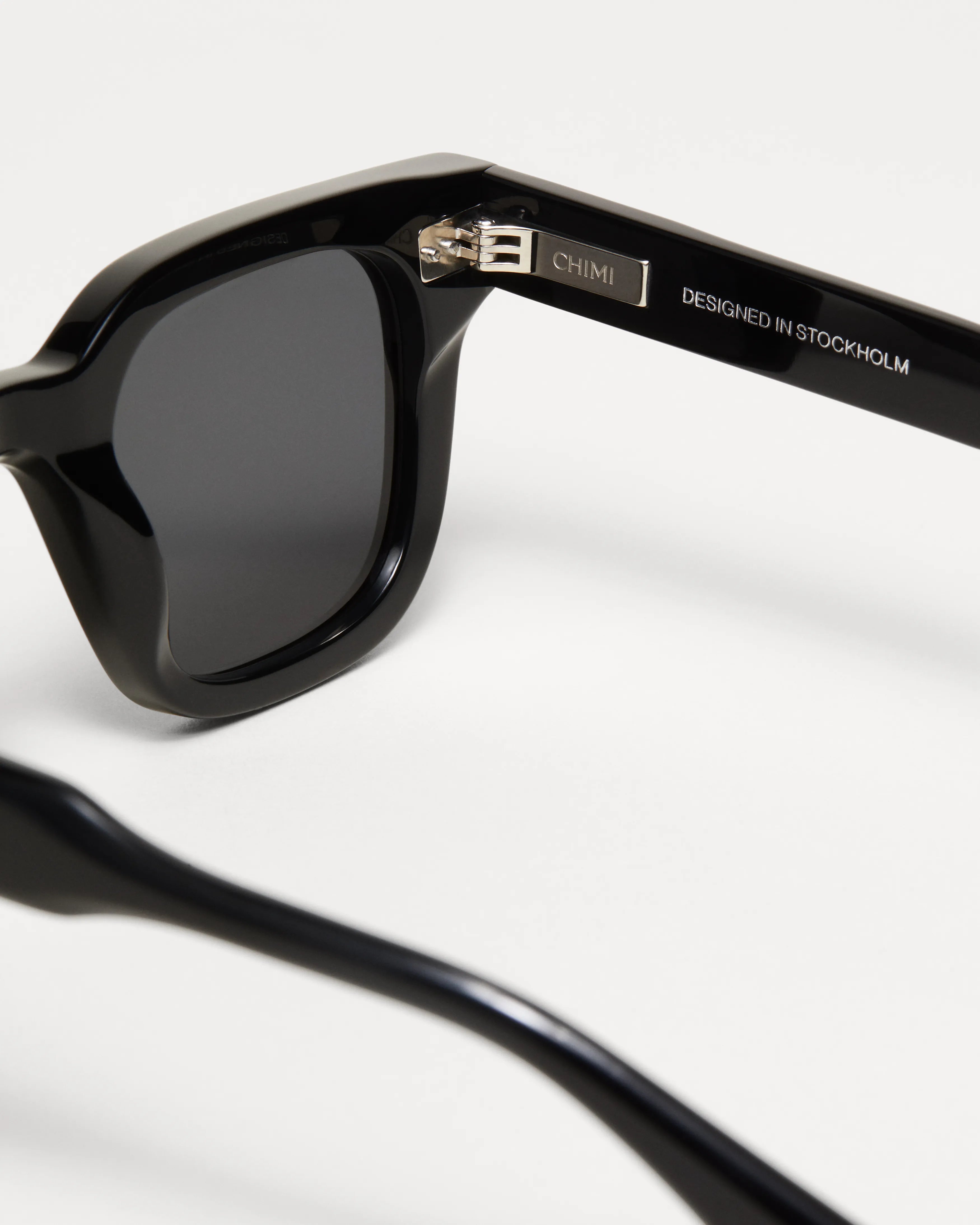 04 Core Black Sunglasses close-up view showing durable frame and anti-scratch lenses, designed in Sweden.