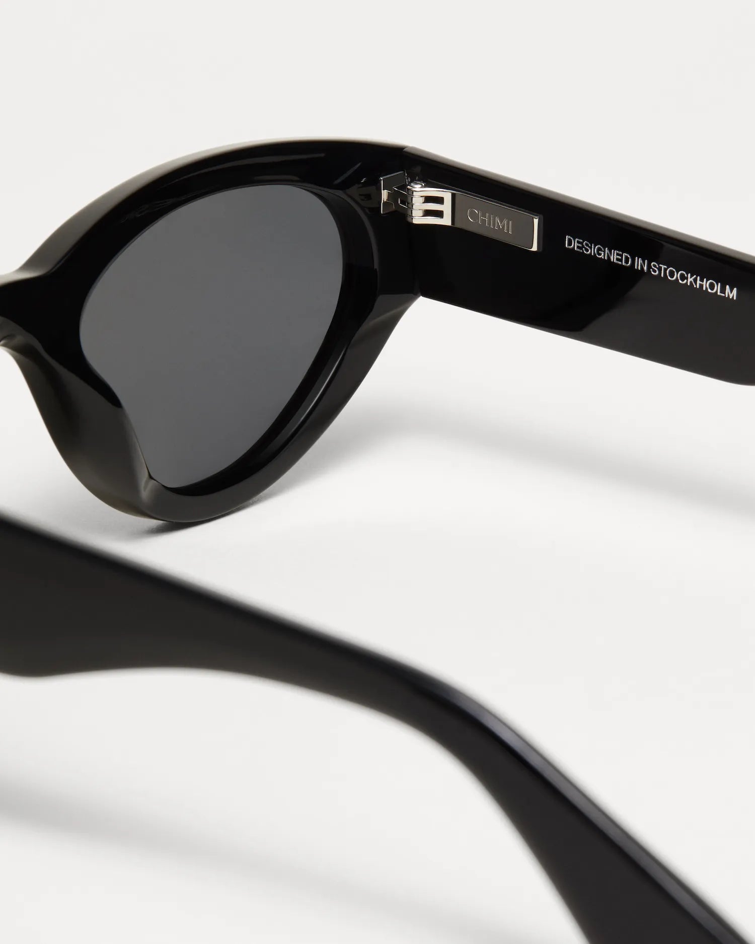Close-up of 06 Core Black Sunglasses showcasing stylish design and quality lenses, designed in Stockholm.