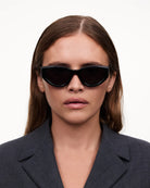 06 Core Black Sunglasses worn by a model, showcasing sleek design and UVA/UVB protection, ideal for everyday use.