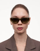 Model wearing 06 Core Green Sunglasses with a chic outfit.