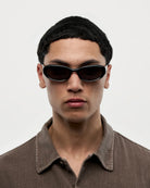 09 Core Black Sunglasses on model, showcasing unisex style and high-quality design with UV protection.