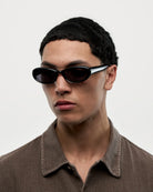 Model wearing 09 Core Black Sunglasses showcasing stylish design and durable material, perfect for UVA and UVB protection.