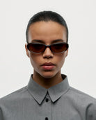 09 Core Brown Sunglasses worn by a model, featuring a sleek design with brown lenses and stylish frame.