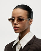 Model wearing 09 Core Ecru Sunglasses with stylish brown lenses and a white collar shirt.
