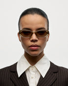 09 Core Green Sunglasses worn by a model in a stylish suit with a classic collar against a neutral background.