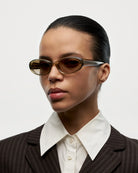 Model wearing 09 Core Green Sunglasses showcasing stylish design and modern aesthetics.