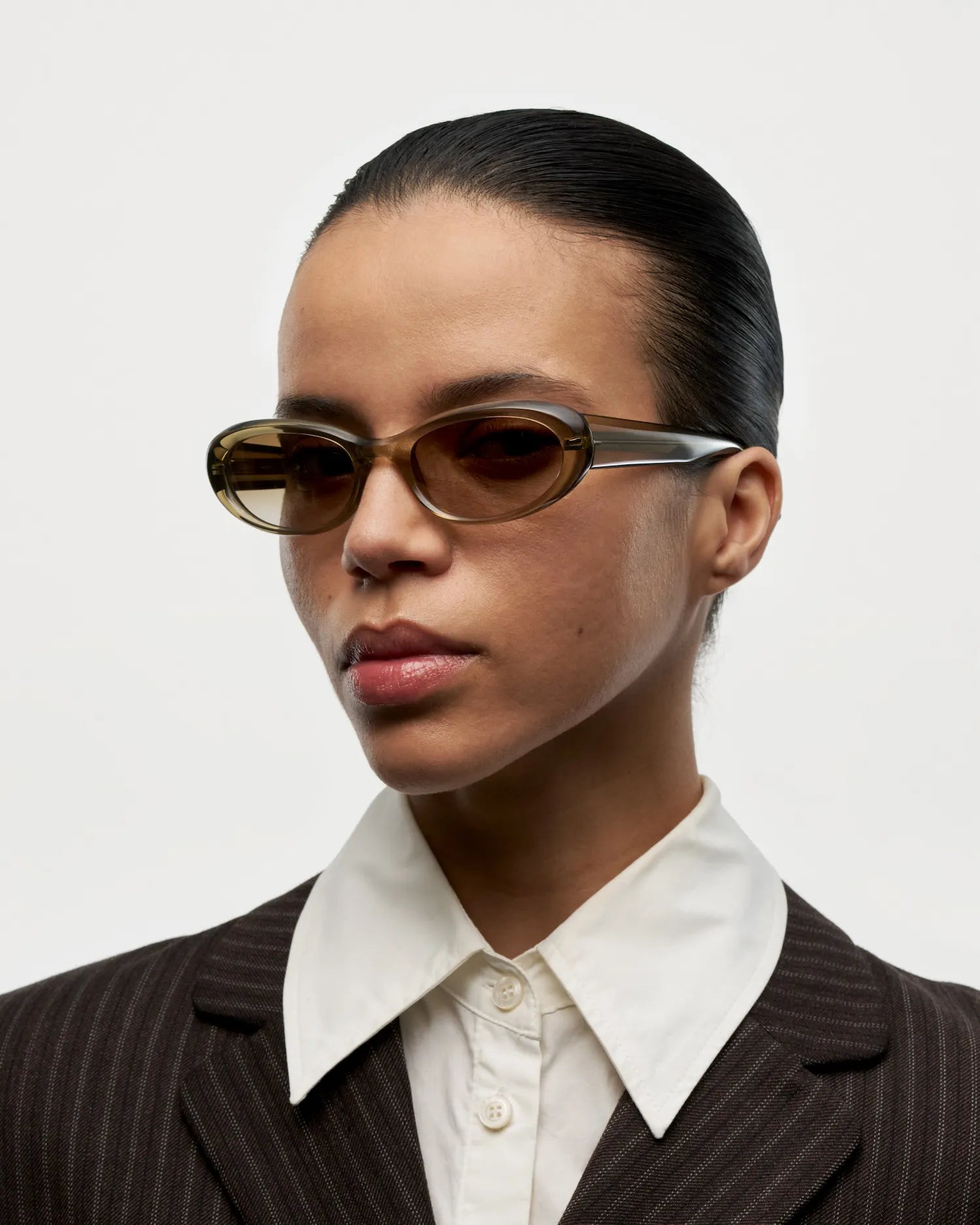 Model wearing 09 Core Green Sunglasses showcasing stylish design and modern aesthetics.