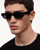 Model wearing 10 Core Black Sunglasses with sleek frame design and dark lenses, showcasing stylish outdoor eyewear.