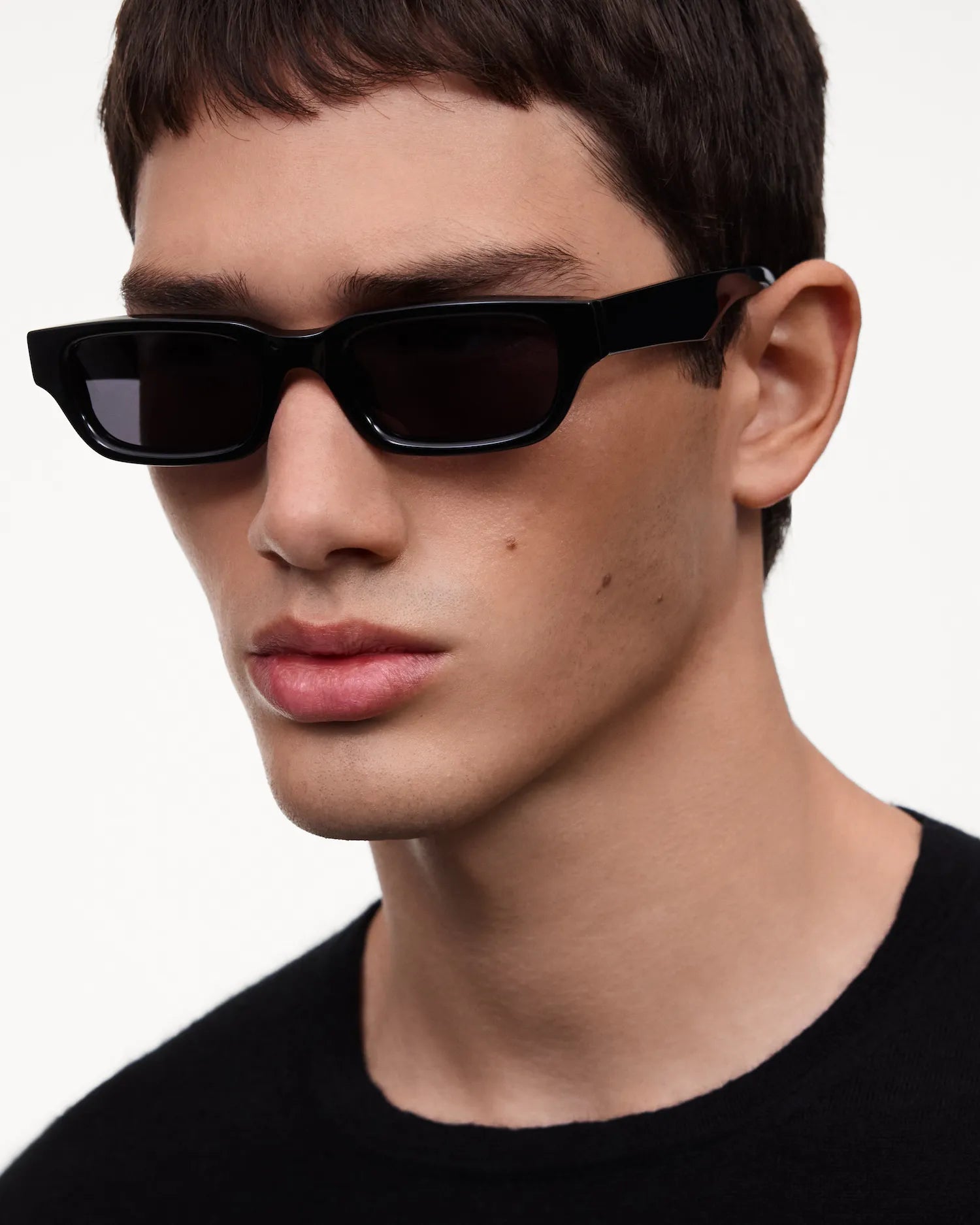 Model wearing 10 Core Black Sunglasses with sleek frame design and dark lenses, showcasing stylish outdoor eyewear.