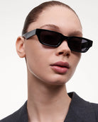 10 Core Black Sunglasses modeled by a woman, showcasing stylish and protective lens design for small to medium heads.