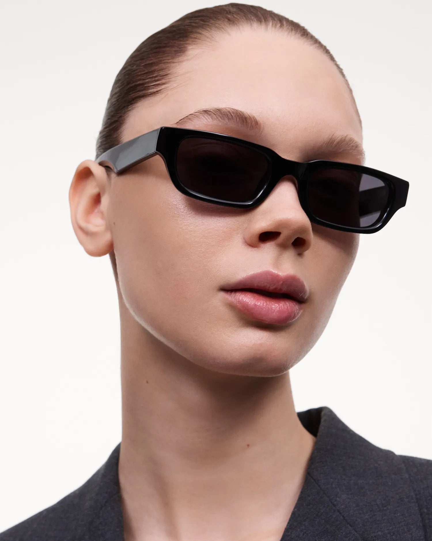 10 Core Black Sunglasses modeled by a woman, showcasing stylish and protective lens design for small to medium heads.
