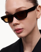 Model wearing 10 Core Brown Sunglasses with stylish frame and tinted lenses, showcasing UV protection and modern design.